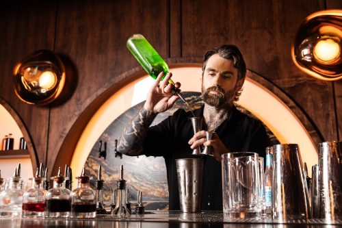 Jax Donahue making a cocktail at Drop Dead Gorgeous