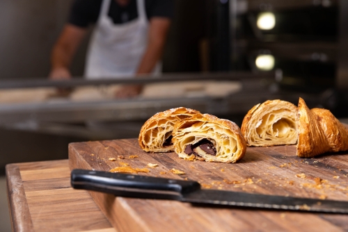 Pastries on display with Baker in the Background at Proof Bread in Mesa AZ ALT2